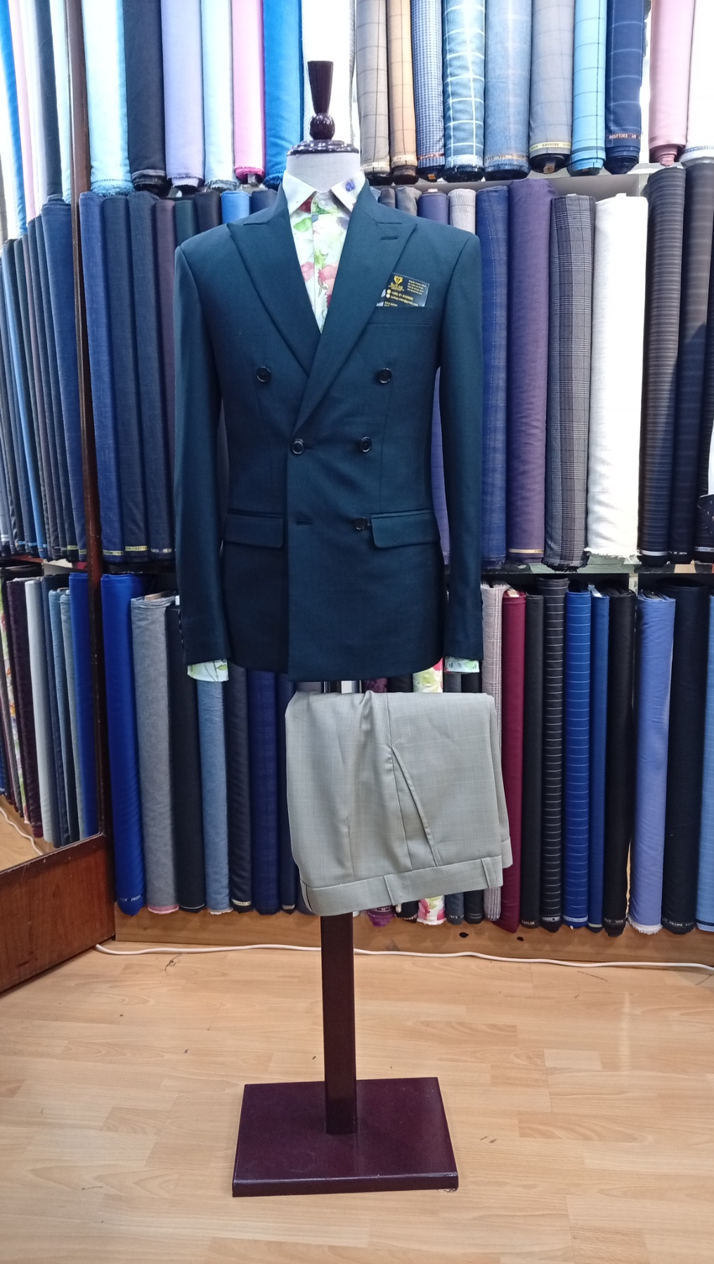 Tailor fitting a client in the atelier